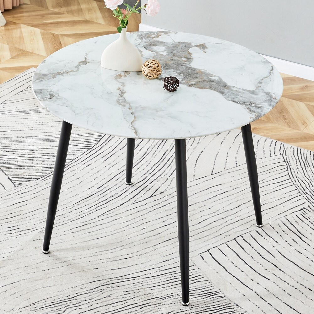 A modern circular dining table with a 0.3 inch thick white imitation marble pattern tabletop and black metal legs