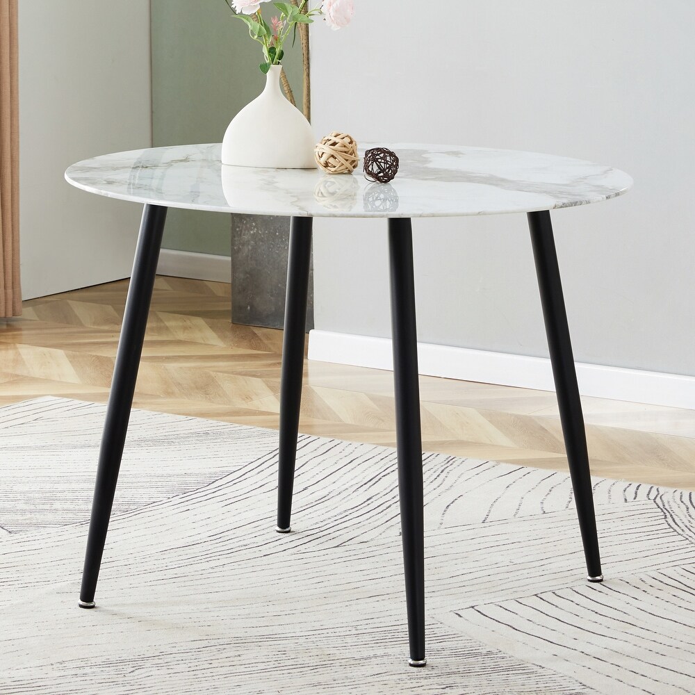 A modern circular dining table with a 0.3 inch thick white imitation marble pattern tabletop and black metal legs