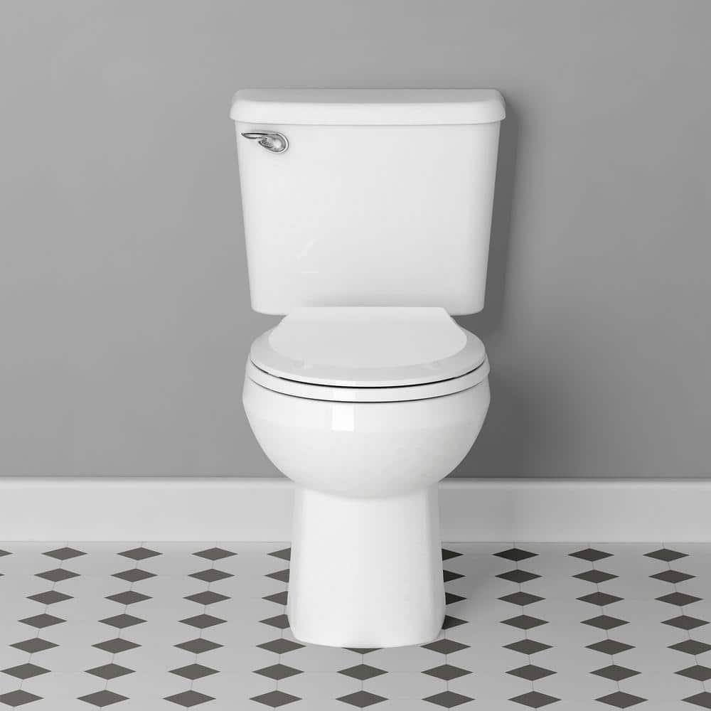 American Standard Reliant 10 in RoughIn 2Piece 128 GPF Single Flush Round Toilet in White Seat Included