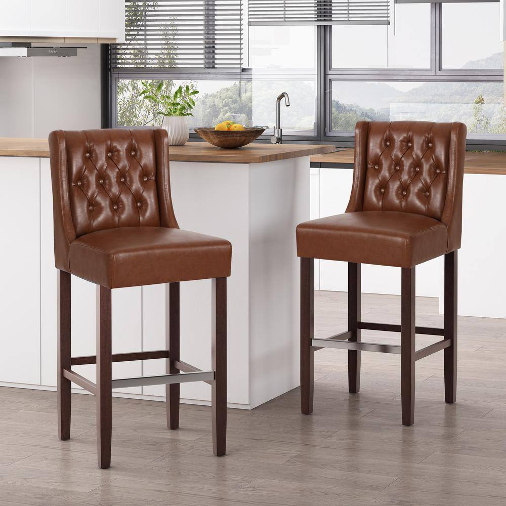 Noble House Bayliss 44.25 in. Cognac Brown High Back Wood Bar Height Foot Rest Bar Stool with Faux Leather Seat (Set of 2) 83320