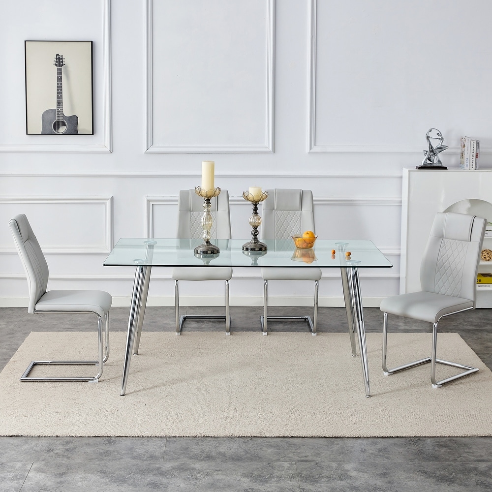 Table and chair set. 1 table and 4 light gray PU chairs. Rectangular glass dining table  and silver metal table legs.