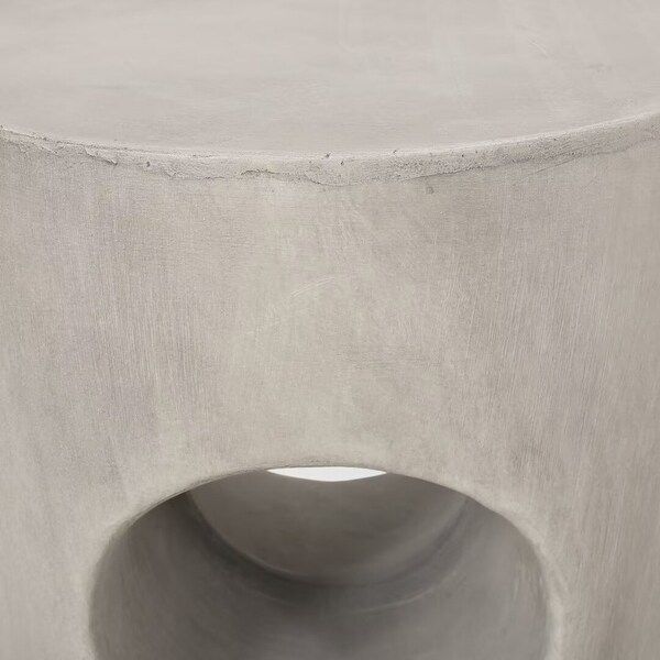 Modern Outdoor side table，with its round tabletop and drum silhouette