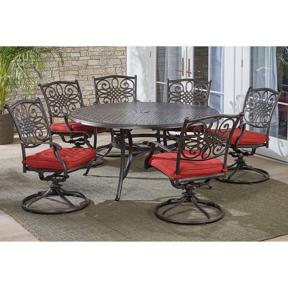 Hanover Traditions 7 Piece Dining Set in Red with a 60 In. Round Cast top Table and Six Swivel Rockers