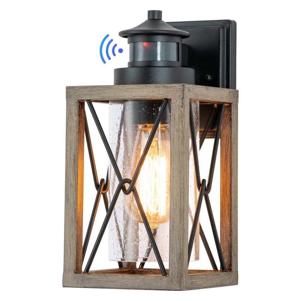 C Cattleya 1-Light Black and Faux Wood Motion Sensing Dusk to Dawn Outdoor Wall Lantern Sconce with Clear Seeded Glass CA2200-W