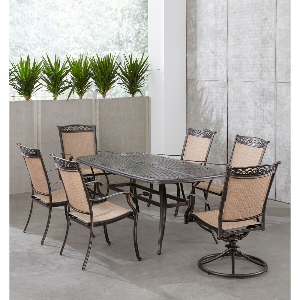 Hanover Fontana 7 Piece Outdoor Dining Set with 2 Sling Swivel Rockers  4 Sling Chairs  and a 38 In. x 72 In. Cast Top Table