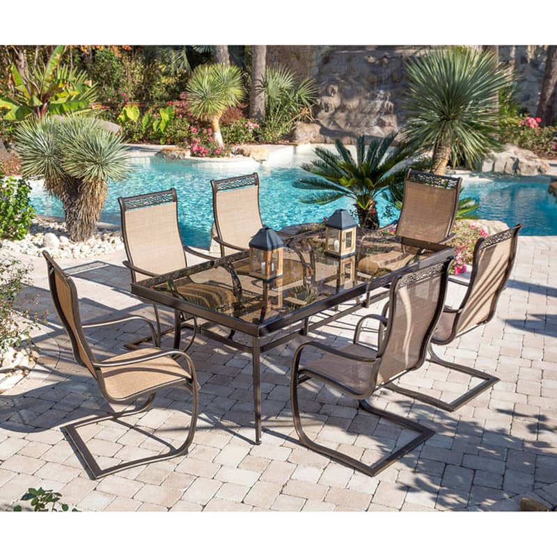 Hanover Monaco 7-Piece Outdoor Dining Set In Tan/Bronze With 6 Spring Sling Chairs， 42 x 84 Glass-Top Table