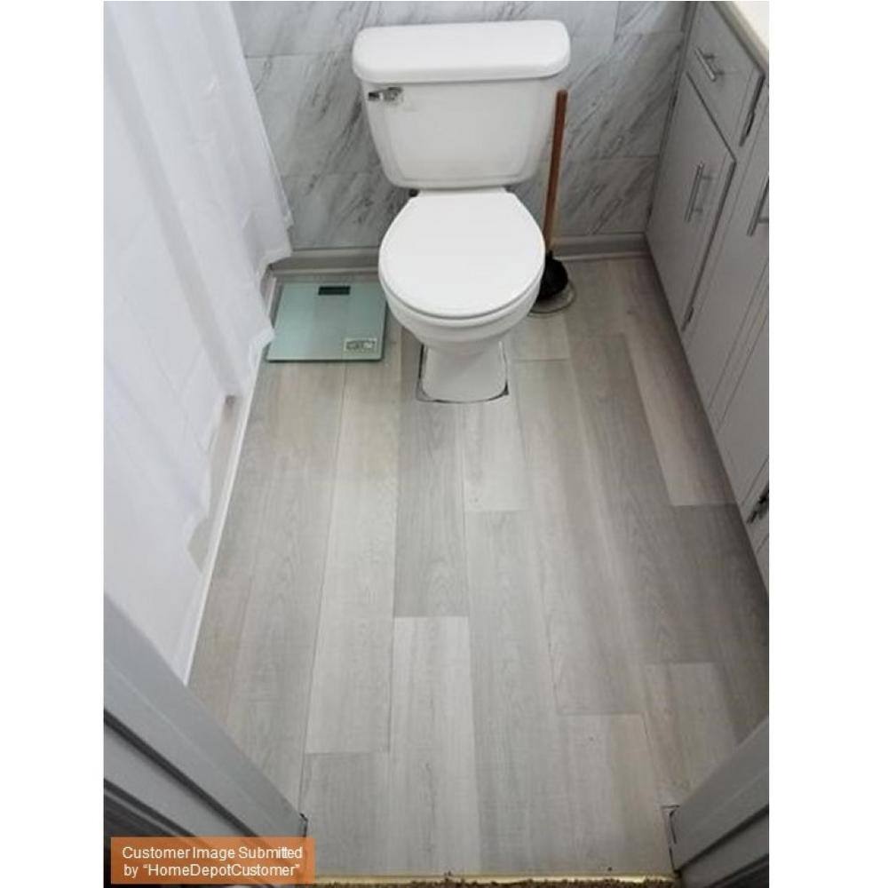 TrafficMaster Sandpiper Oak 4 MIL x 6 in. W x 36 in. L Grip Strip Water Resistant Luxury Vinyl Plank Flooring (24 sqftcase) 03919