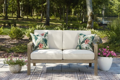 Signature Design by Ashley Outdoor Barn Cove Wicker Loveseat with Cushion, Brown