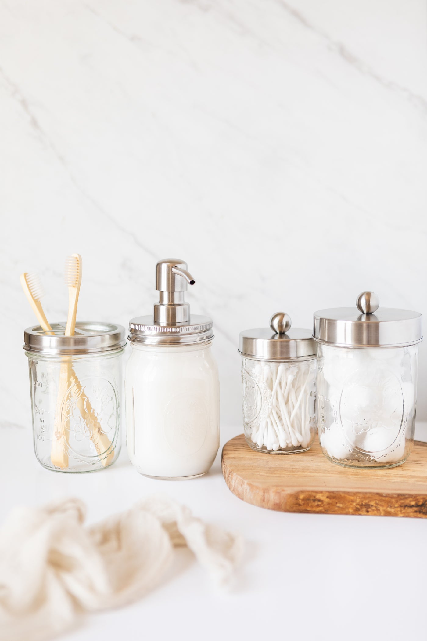 Mason Jar Bathroom Gift Set (4 pcs) - Lotion/Soap Dispenser， Toothbrush Holder， Q-Tip Storage Jars - Farmhouse Home Decor for Vanity Organization - Luxury Bathroom Accessories - Stainless Steel