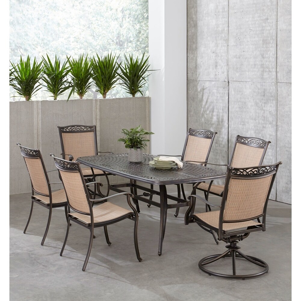 Hanover Fontana 7 Piece Outdoor Dining Set with 2 Sling Swivel Rockers  4 Sling Chairs  and a 38 In. x 72 In. Cast Top Table