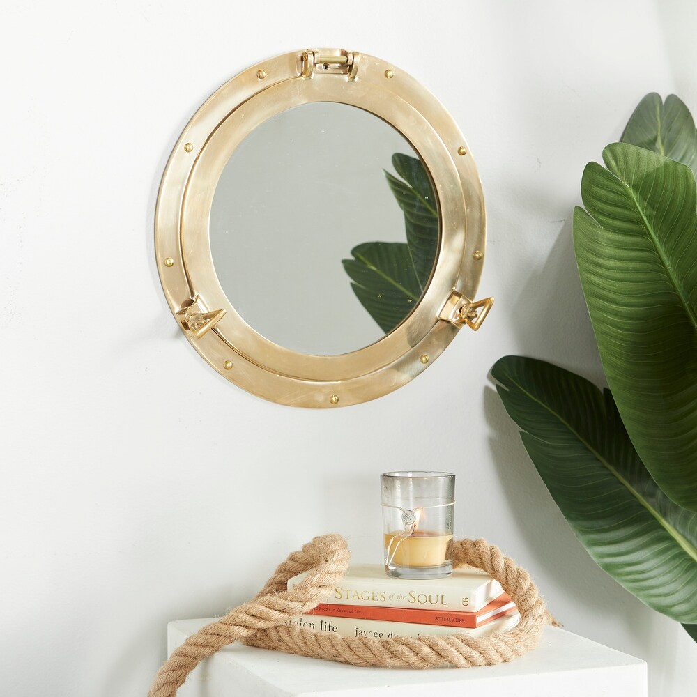 The Novogratz Gold Brass Sail Boat Wall Mirror with Port Hole Detailing