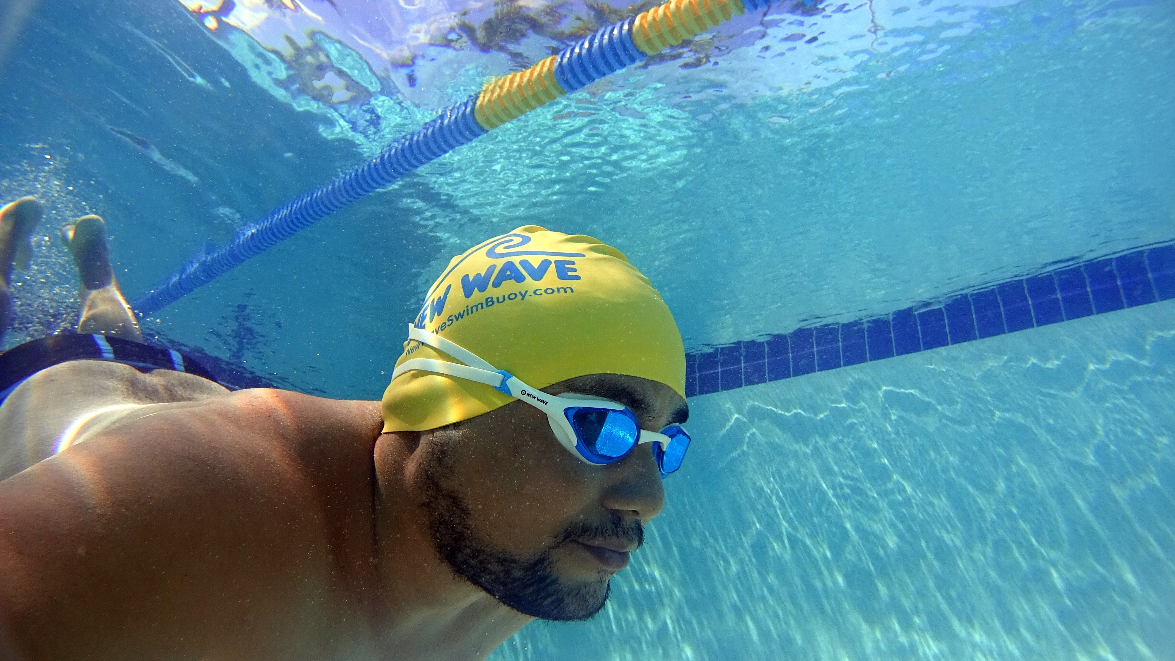 Swim Goggles by New Wave Swim Buoy {Blue Ice = Blue Lens in White Frame} Anti Fog Lenses, Silicone In-Socket Eye Cups, Four Interchangeable Nose Bridges and Adjustable Strap for Triathlon