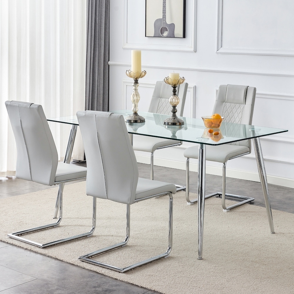 Table and chair set. 1 table and 4 light gray PU chairs. Rectangular glass dining table  and silver metal table legs.