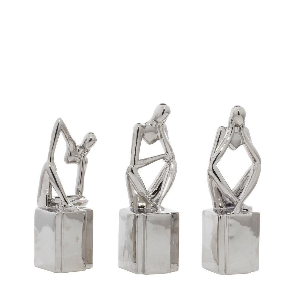 CosmoLiving by Cosmopolitan Silver or Gold Porcelain Sitting Thinker People Sculpture (Set of 3)