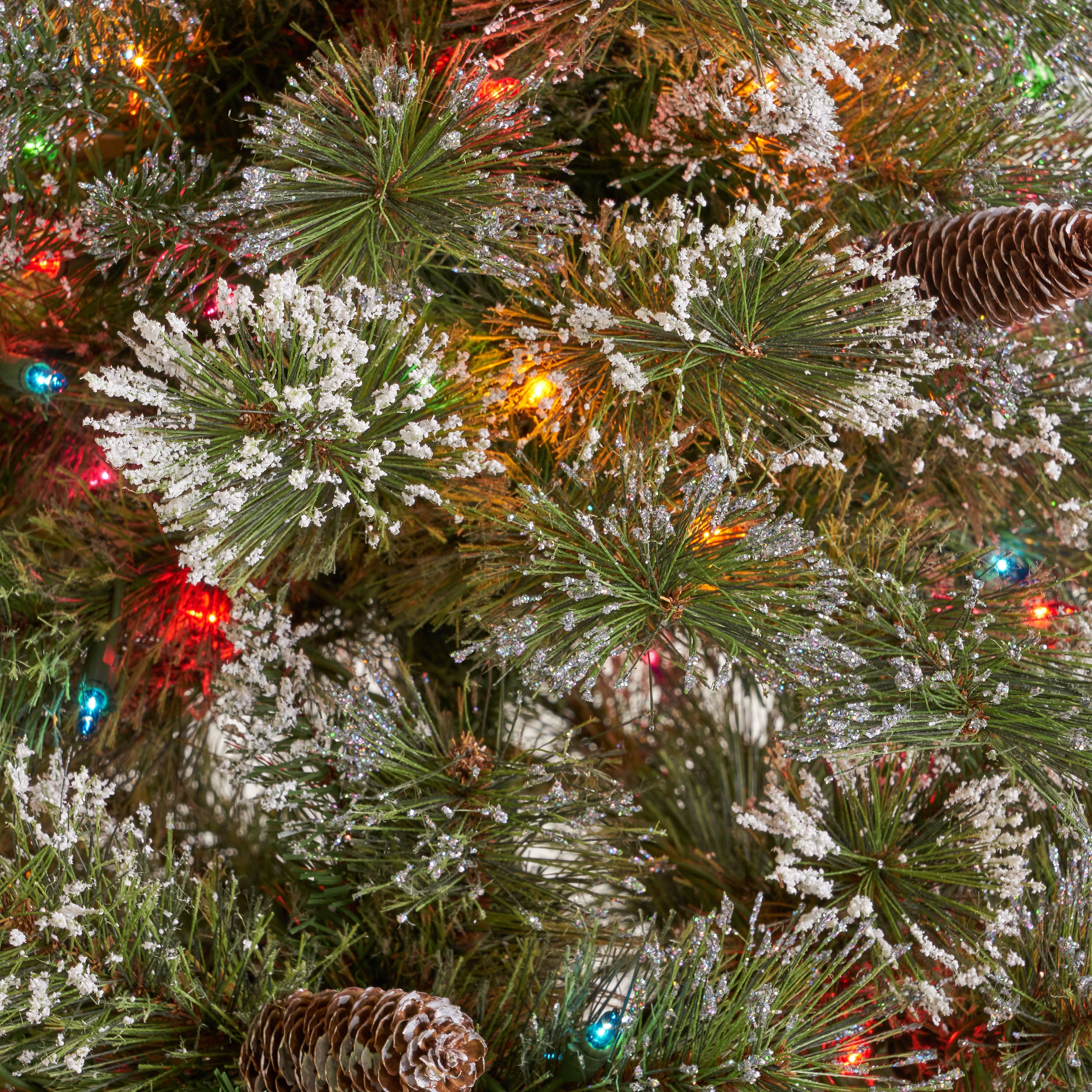 9-foot Mixed Spruce Hinged Artificial Christmas Tree with Snow and Glitter Branches and Frosted Pinecones