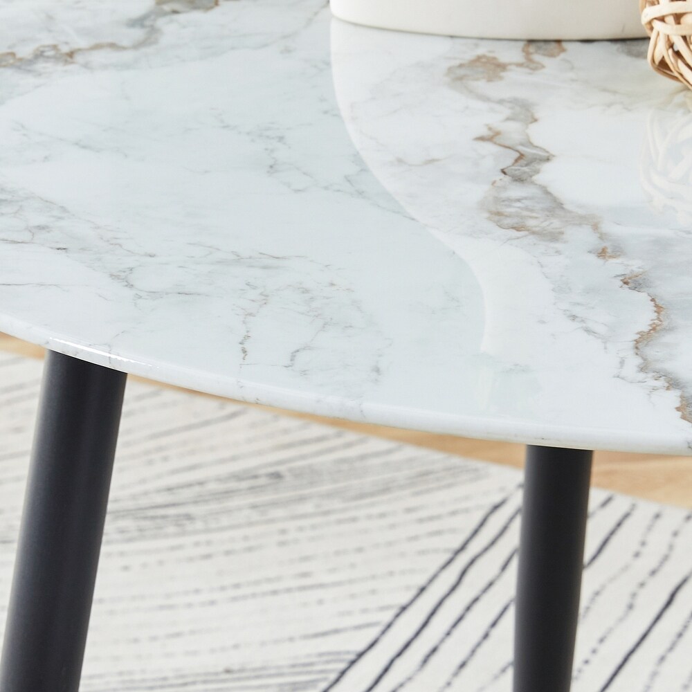 A modern circular dining table with a 0.3 inch thick white imitation marble pattern tabletop and black metal legs