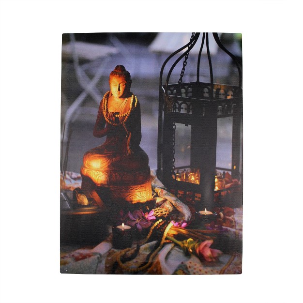 Led Flickering Candles In A Metal Lantern With Buddha Wall Art