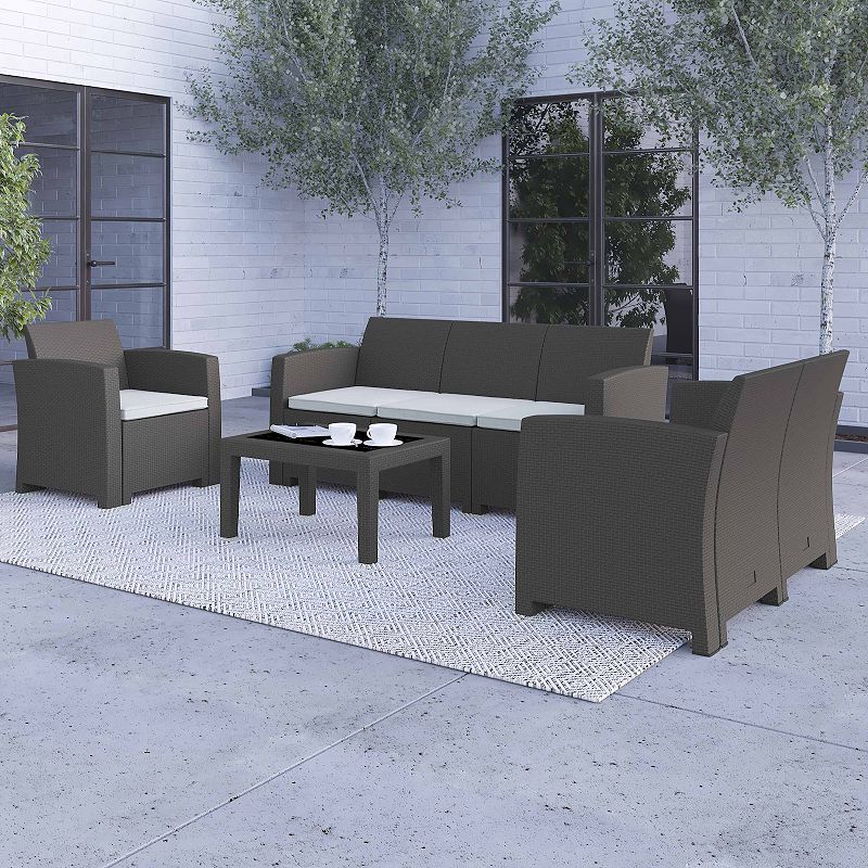 Merrick Lane Greta 4 Piece Faux Rattan Patio Furniture Set with Included Cushions， Chair， Sofa， Loveseat and Coffee Table