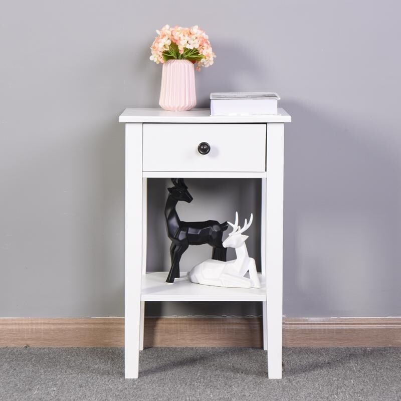 The white bathroom floor to ceiling storage table has a drawer