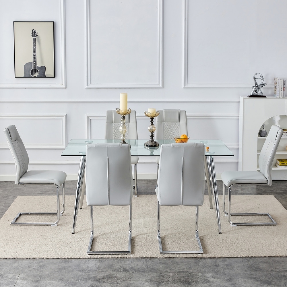 Table and chair set. 1 table and 4 light gray PU chairs. Rectangular glass dining table  and silver metal table legs.