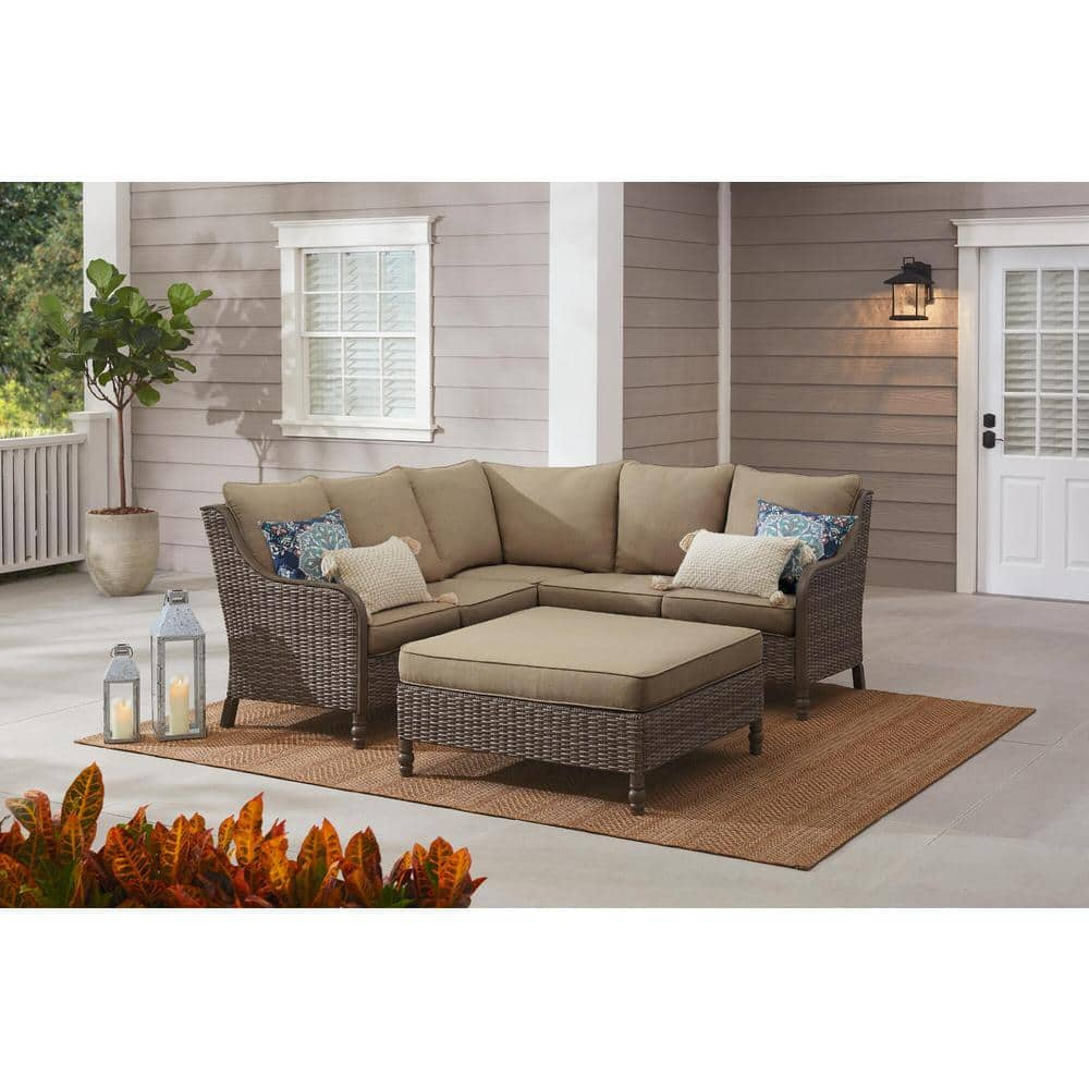 Hampton Bay Windsor 4-Piece Brown Wicker Outdoor Patio Sectional Sofa with Ottoman and CushionGuard Biscuit Tan Cushions H193-01203800