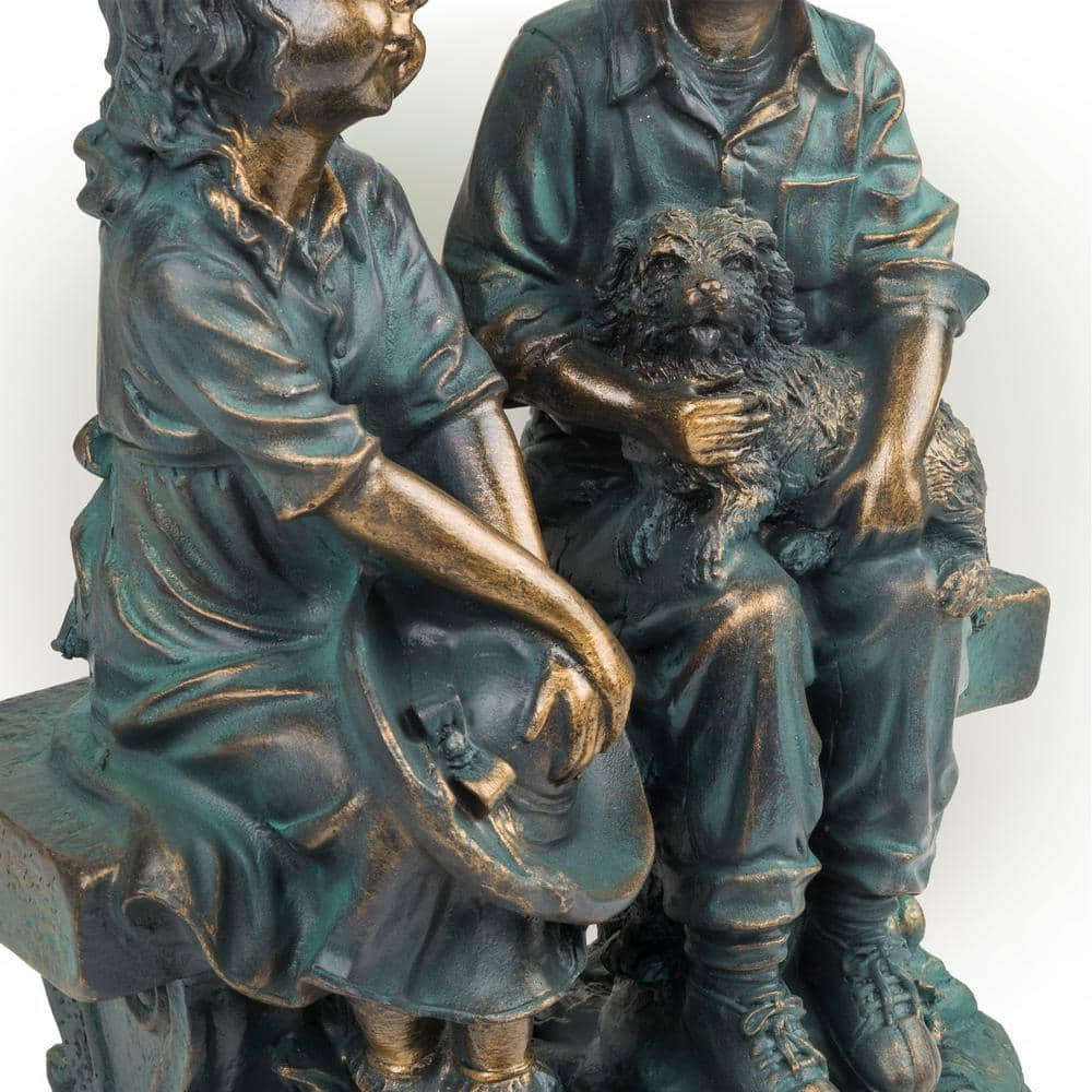 Alpine Corporation 16 in. Tall Indoor/Outdoor Girl and Boy Sitting on Bench with Puppy Statue Yard Art Decoration GXT264