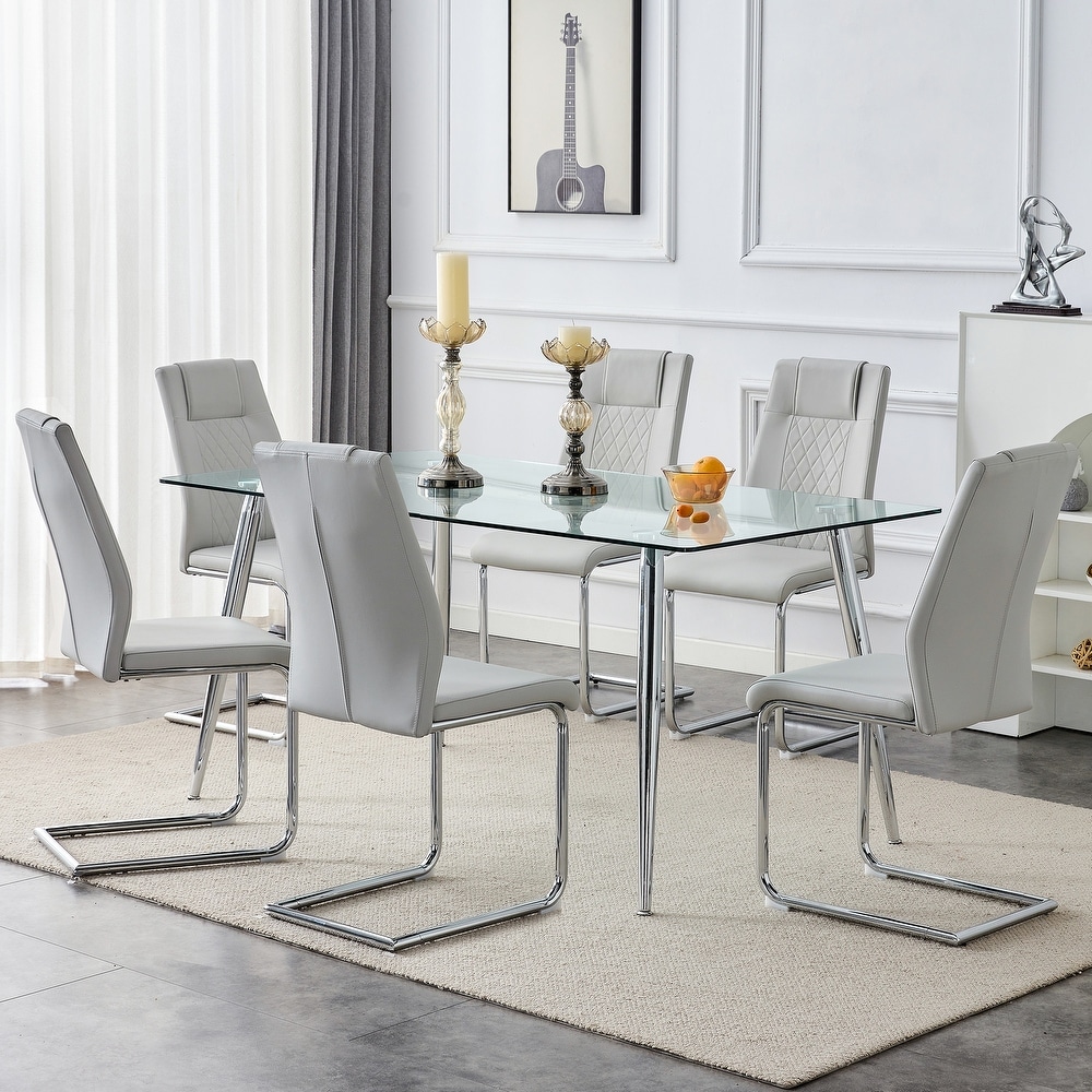 Table and chair set. 1 table and 4 light gray PU chairs. Rectangular glass dining table  and silver metal table legs.