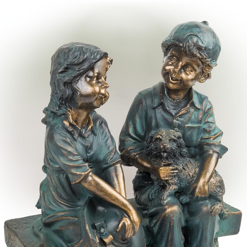 Alpine Corporation 16 in. Tall Indoor/Outdoor Girl and Boy Sitting on Bench with Puppy Statue Yard Art Decoration GXT264