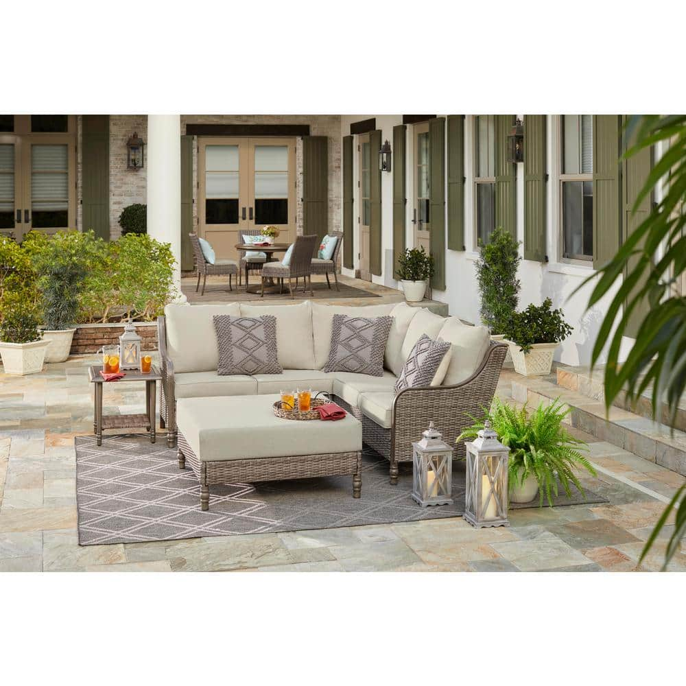 Hampton Bay Windsor 4-Piece Brown Wicker Outdoor Patio Sectional Sofa with Ottoman and CushionGuard Biscuit Tan Cushions H193-01203800